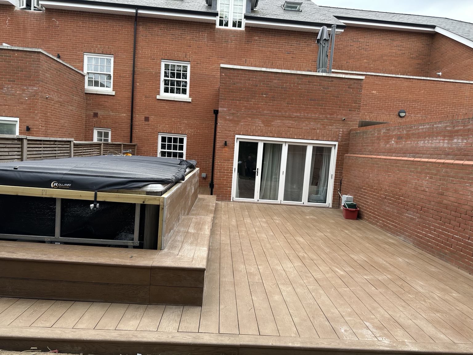 Laid composite deck boards and edging with the hot-tub enclosure in progress