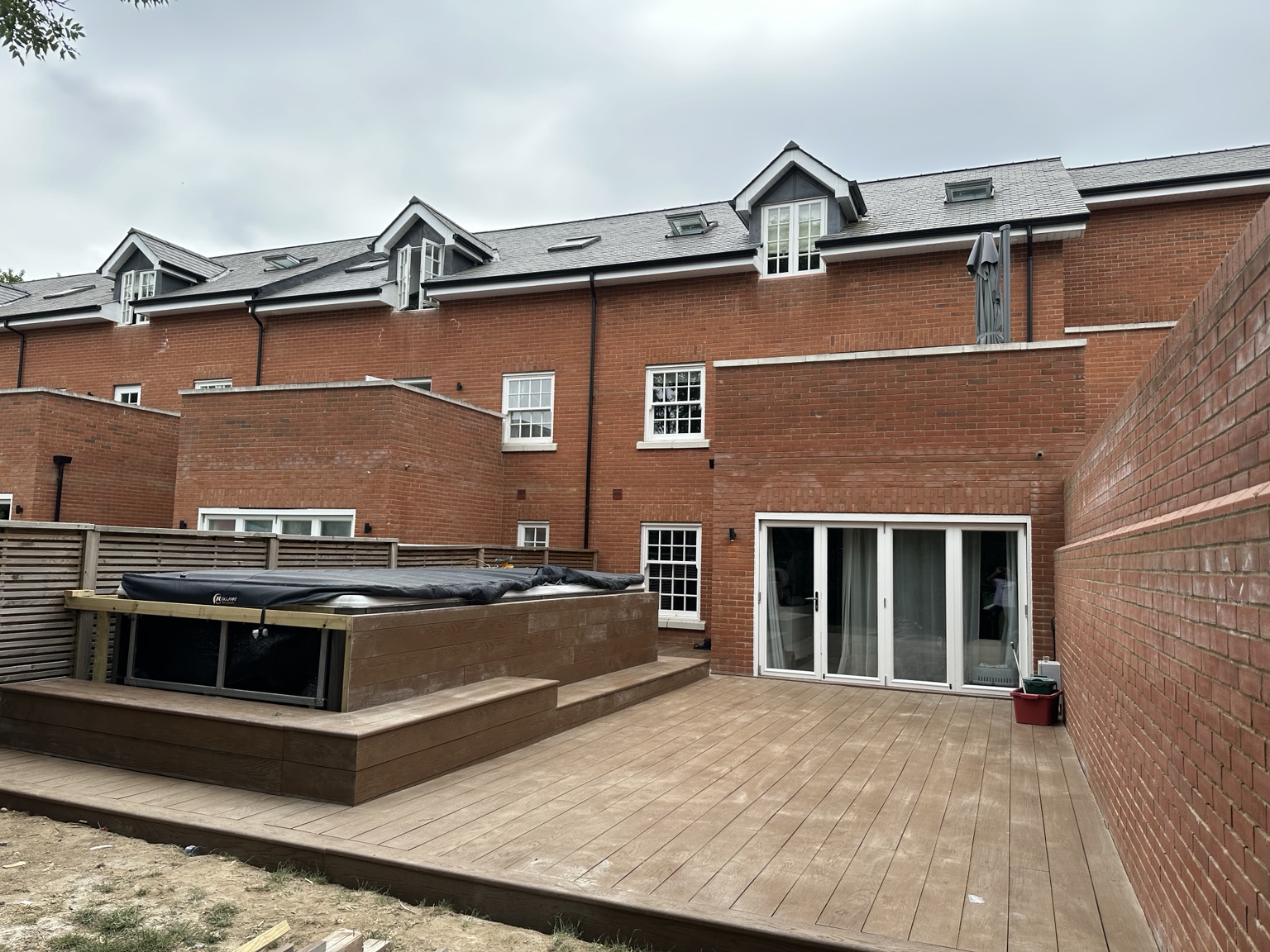 Composite decking installation around a garden hot tub